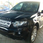 Before and after photographs of a damaged, black, Range Rover that was repaired by Elite Paint & Body Shop in West Palm Beach, FL.